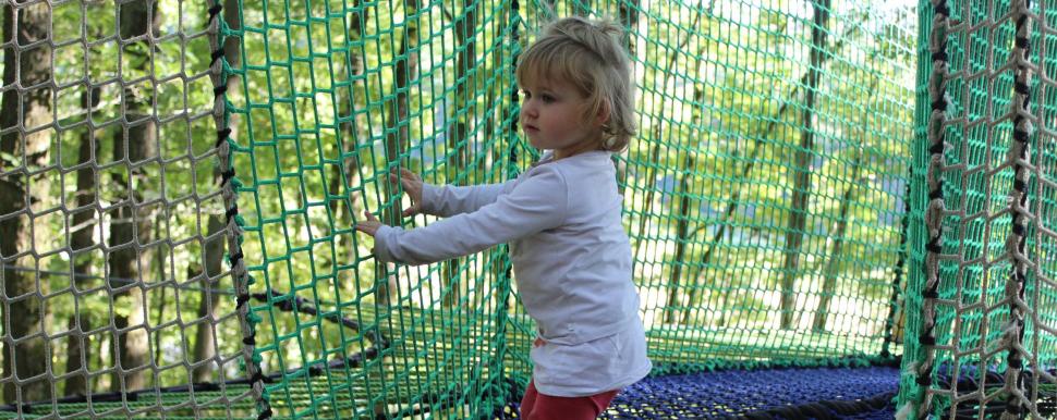 Enfant joue dans un hamac à bonds au Parc Argonne Découverte