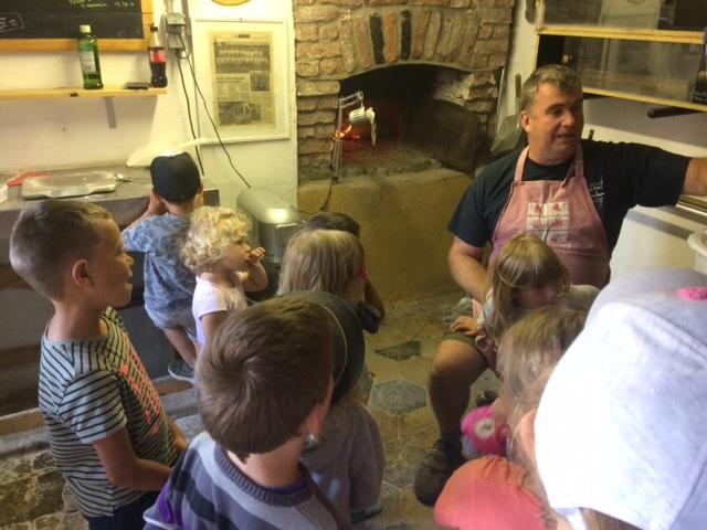 Explanation by the bread oven at Charming Meadow Farm
